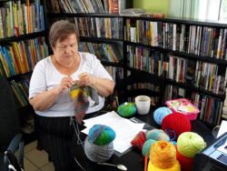 Czytelniczka w trakcie warsztatów z rzędów skróconych na drutach uczy się robić chustę metodą Swing Knitting