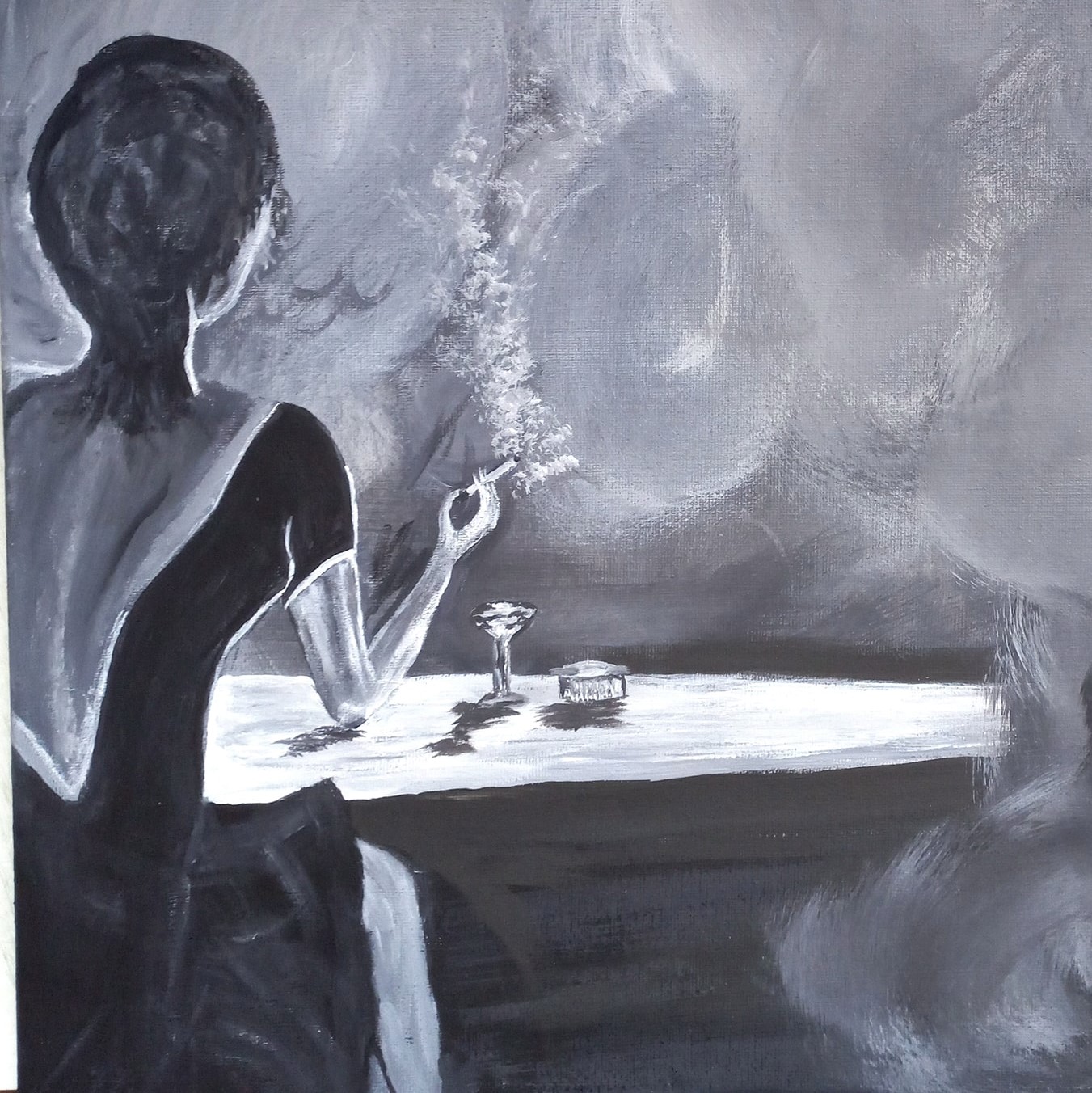 Jeden z obrazów Zbigniewa Piergiesa, a na nim siedząca tyłem przy stoliku kobieta